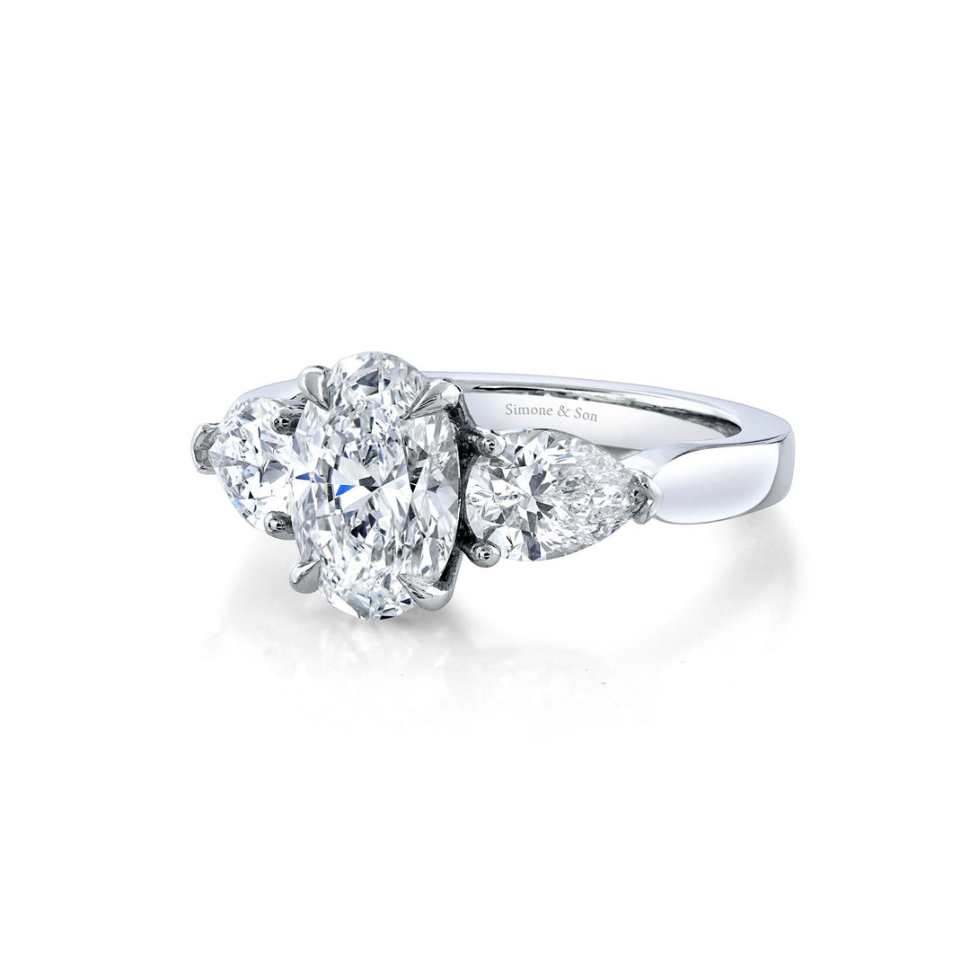 Platinum - 3 Stone Ring featuring 2 pear shape side stones.